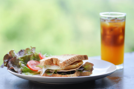 ham and cheese sandwichor egg sandwich with salad and orange black coffee or  orange americanoの写真素材