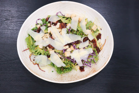 caesar salad or vegetable salad with bacon and cheese for serveの写真素材
