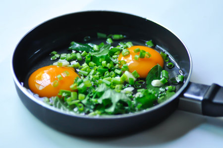 fried egg or sunny side up egg with vegetable topping before fry in the panの写真素材