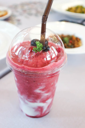 smoothie or strawberry yogurt smoothie, mixed berry smoothie with strawberry with blueberry topping for serveの写真素材