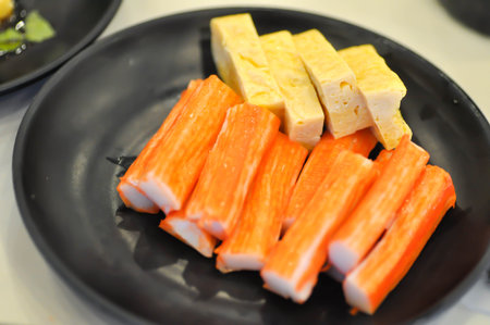 Japanese omelete, japanese omelette or sweet egg or sweetened egg or tamagoyaki or Japanese rolled omelette and imitation crab or crab stick for serveの写真素材