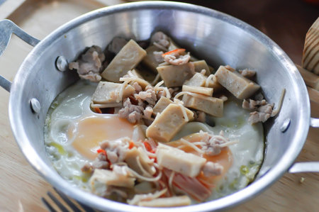 Pan fried eggs with toppings , Skillet Egg or fried egg with sausage and minced pork topping for serveの写真素材