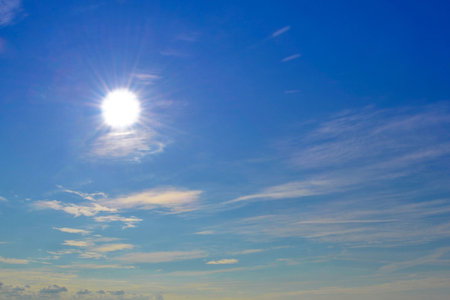 Nice blue sky with sun-rays and fine cloudsの写真素材