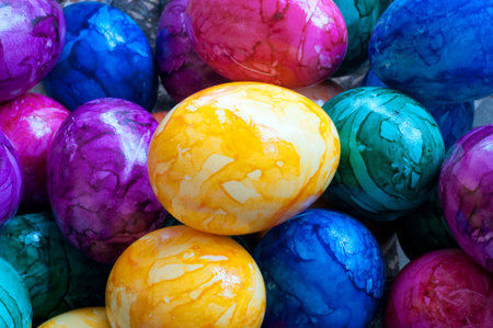 Many colored Easter eggs in a basket