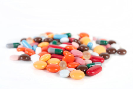 Many different pills on white background, focus in frontの写真素材