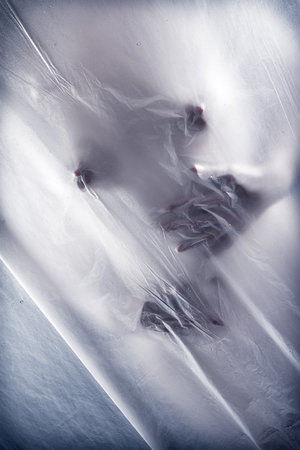 Sexy young woman touching herself behind transparent wet curtain の写真素材