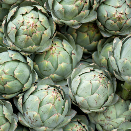 A pile of artichokes at a marketの写真素材