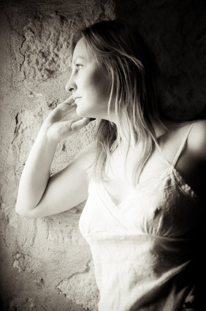 Portrait of a thoughtful young woman, black and white with little grain addedの写真素材