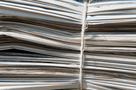 Closeup of a heap of old newspapers bound together