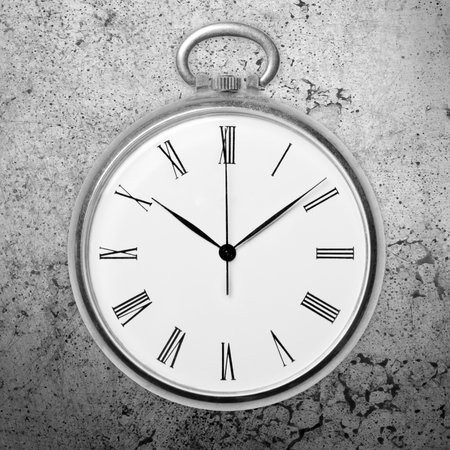 Antique golden pocket watch on grunge background, monochrome. Concept of time, past or deadlineの写真素材