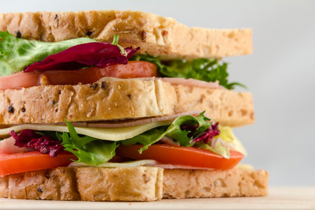 fresh sandwich bread with tomatoes lettuce and ham. Close up