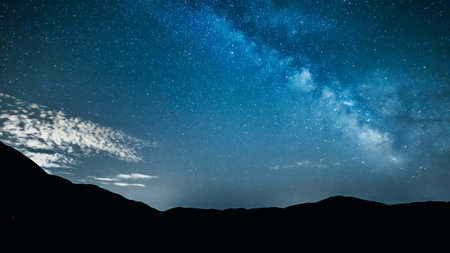 night sky stars with milky way over mountainsの写真素材