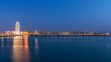 Rimini waterfront cityscape at evening. Urban night lightsの写真素材