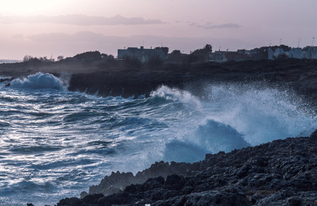 storm seascape at dusk. sunset sea over cliff and rocks. Taranto coastlineの写真素材