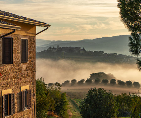 dawn rural landscape with light fog. Italy sunrise panorama. country house.の写真素材