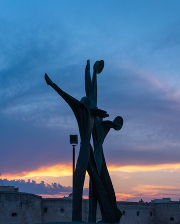 Taranto, Puglia, Italy - 10 august 2018: Silhouette Monument to the Sailor made in bronze in 1974 by the sculptor Vittorio Di Cobertaldo at sunsetのeditorial素材