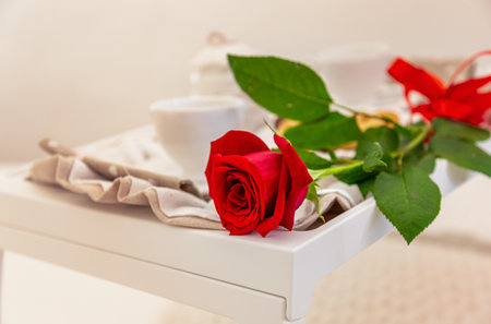red rose on breakfast set table set  in luxury hotel suite. Love celebration, Valentine day.の写真素材