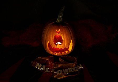 Halloween Pumpkin in dark atmosphere. Creepy smile, horror symbolの写真素材