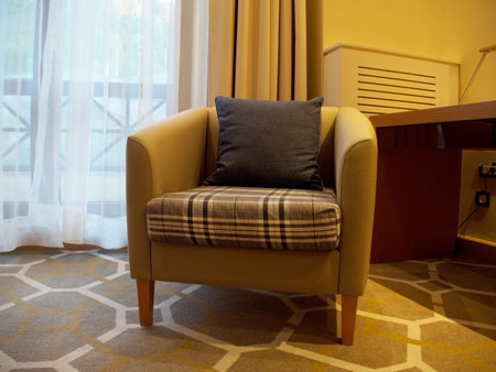 A cozy armchair with a pillow in room of the Novotel hotel. Russia Sochi 05.10.2019のeditorial素材