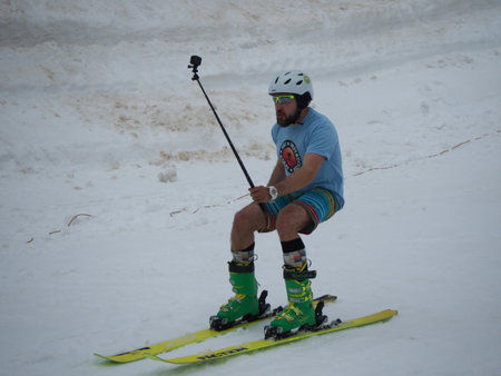 A skier shoots himself on camera takes a selfie ski resort Gorki-gorod. Russia Sochi 05.11.2019のeditorial素材