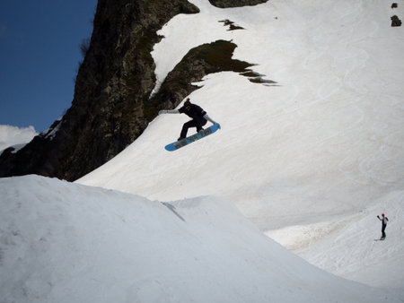 Guy snowboarder jumps on a springboard ski resort Gorky-gorod. Russia Sochi 05.11.2019のeditorial素材