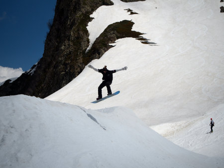 Guy snowboarder jumps on a springboard ski resort Gorky-gorod. Russia Sochi 05.11.2019のeditorial素材