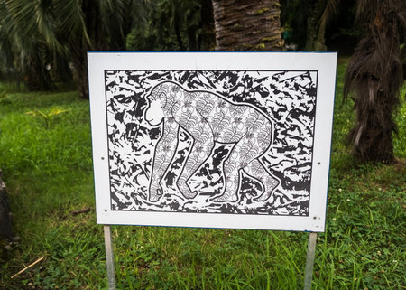 Stand with a painted monkey on a background of grass. Park Arboretum. Russia Sochi 06 23 2019のeditorial素材