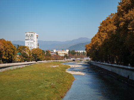Russia, Sochi 05.10.2019. Sochinka river and embankment with beautiful autumn treesのeditorial素材