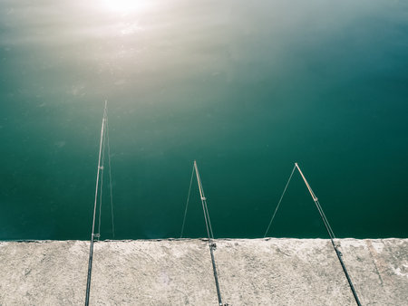 Three fishing rods on a sunny dayの写真素材