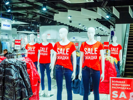 Sochi, Russia - 14 December 2019. White mannequins in red T-shirts with SALE inscription stand in a row inside the storeのeditorial素材