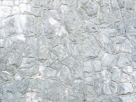 Background gray textured wall with rough patterned masonry. Full screen photoの写真素材