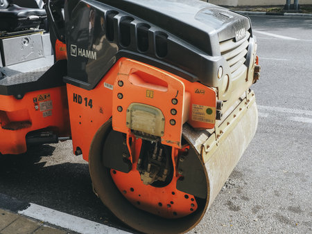 Russia, Sochi 05.07.2020. A fragment of an orange black road roller parked on the side of the road