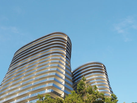 Russia, Sochi 05.07.2020. Two highrise new buildings of an unusual oval shape against a blue skyのeditorial素材