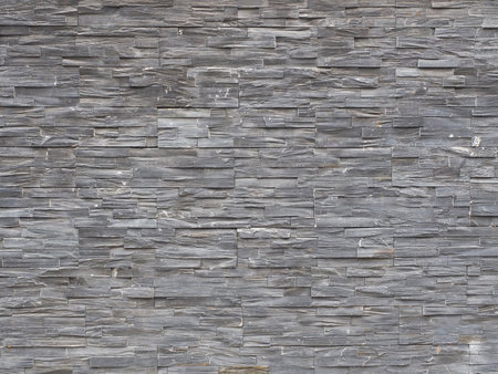 Wall with decorative gray textured tile cladding. Texture not seamlessの写真素材