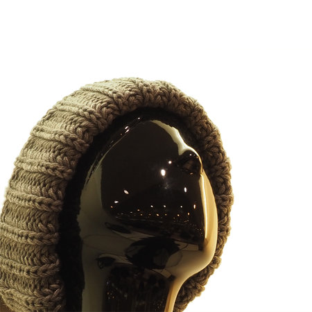 Head of black abstract female mannequin in knitted winter hat on white backgroundの写真素材