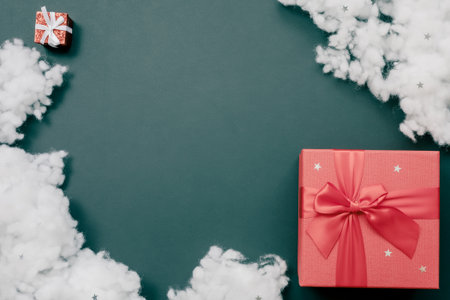 Composition of two red gift boxes and a fiberfil on an emerald background. Holiday postcardの写真素材