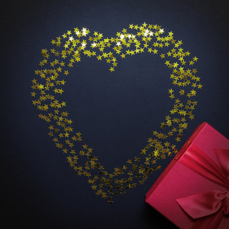 Valentines Day card. Festive romantic picture with a shiny heart and a gift box. Flatlay composition