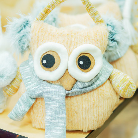 Soft plush toy owl with headphones and knitted scarf. Winter childrens giftの写真素材