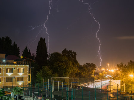 Russia Sochi 22.08.2019. Lightning strike against the background of the city evening landscapeのeditorial素材