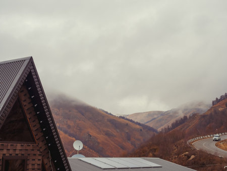 The top of the house is located in the highlands with a view of the road and clouds descending on...
