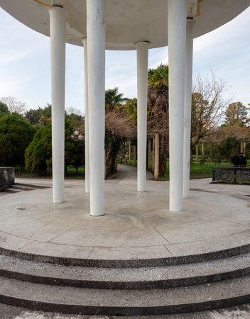 A round high gazebo with white columns is located in the center of the evergreen southern arboretum.の写真素材