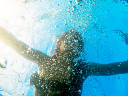 Woman floating in blue transparent bubble water. Summer sea vacation.