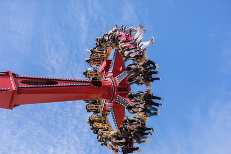 Russia, Sochi 14.05.2022. A huge rotating round attraction raises the joyful youth high to the sky....