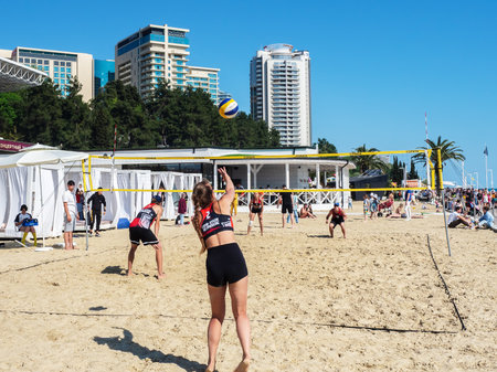 Russia, Sochi 28.05.2022. Play volleyball on the city beach. Team game of beach volleyball on the sea coast. City Day in Sochiのeditorial素材