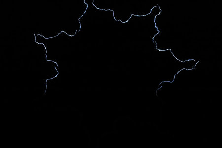 A snowflake from bright glowing lightning. Laser show. Blurred image.