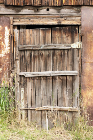 An old small wooden gate by the barn. Close-upの写真素材
