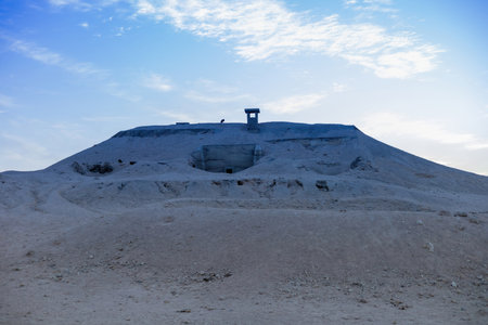 Discover the serene beauty of an ancient desert fortress silhouetted against a blue evening sky. the barren landscape and simple architecture evoke a sense of solitude and mystery. ideal for themes of history, exploration, and tranquility, this image timeless allure of remote landmarks.の写真素材