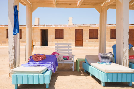 Beach cabana with colorful lounge chairs and towelsの写真素材