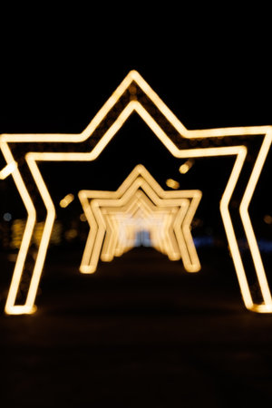 Illuminated star-shaped light tunnel at night.の写真素材
