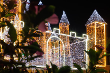 Illuminated castle structure with colorful lights.の写真素材